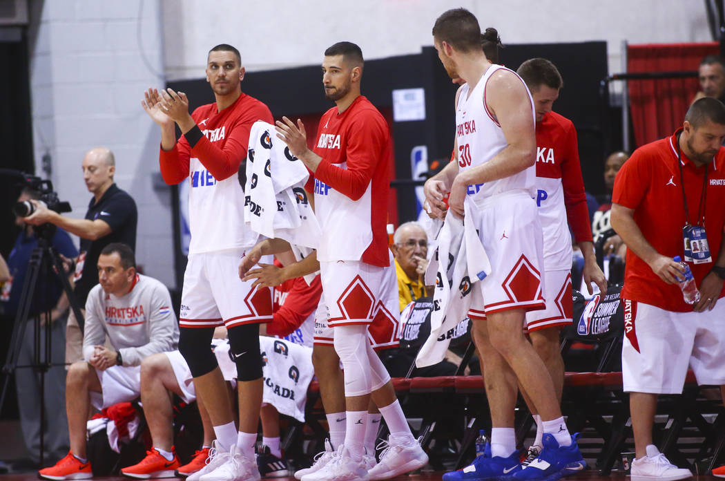 Croatia players cheer on their teammates as they play the Detroit Pistons during the first quar ...