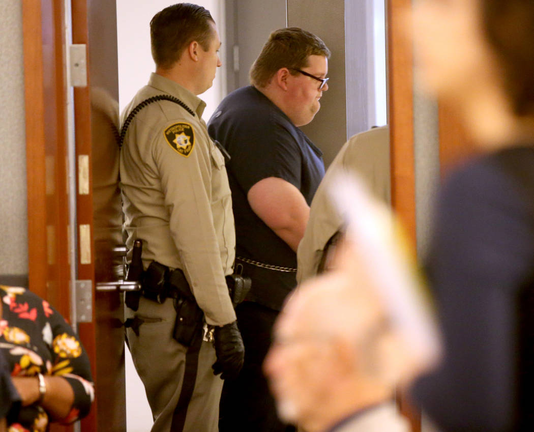 Security guard Brian William Love prepares to appear in court at the Regional Justice Center in ...