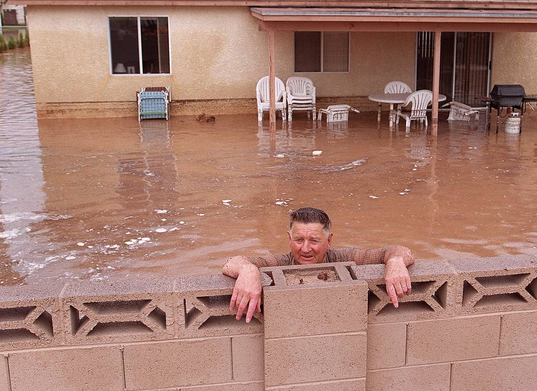 A man stands in the backyard of his flooded home during the 1999 flood. (Las Vegas Review-Journal)