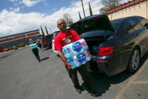 Las Vegas resident Randy Davis makes a water donation to Metro Pizza during a water bottle driv ...