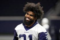 Dallas Cowboys running back Ezekiel Elliott smiles as he walks off the field after participatin ...