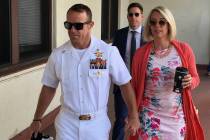 Navy Special Operations Chief Edward Gallagher, left, walks with his wife, Andrea Gallagher as ...