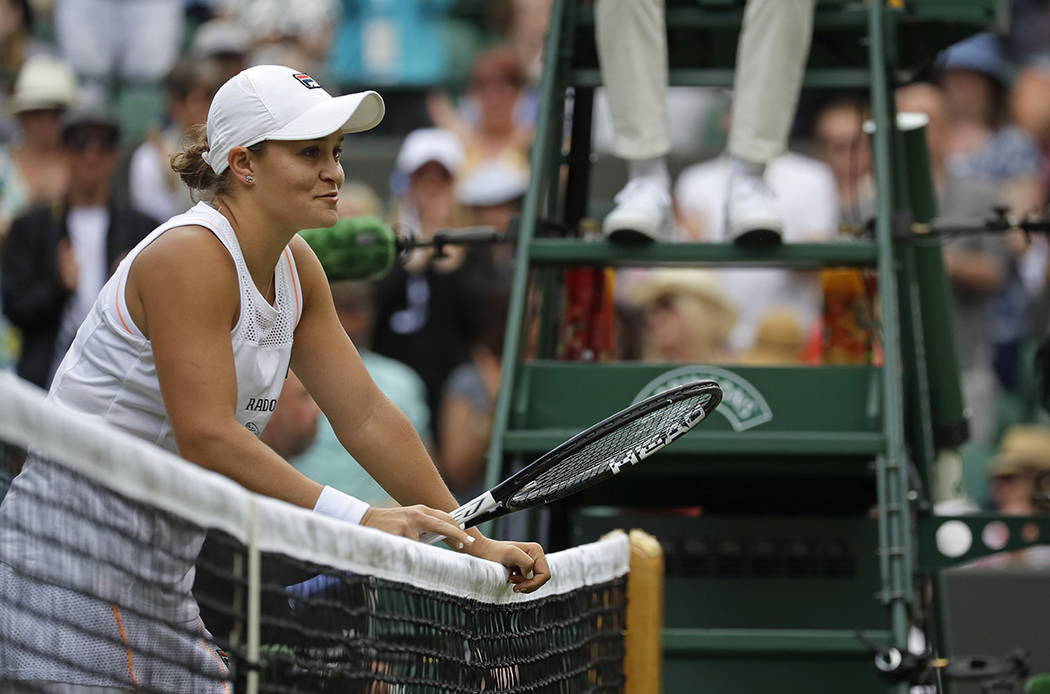 Australia's Ashleigh Barty waits at the net after beating China's Saisai Zheng in their Women's ...
