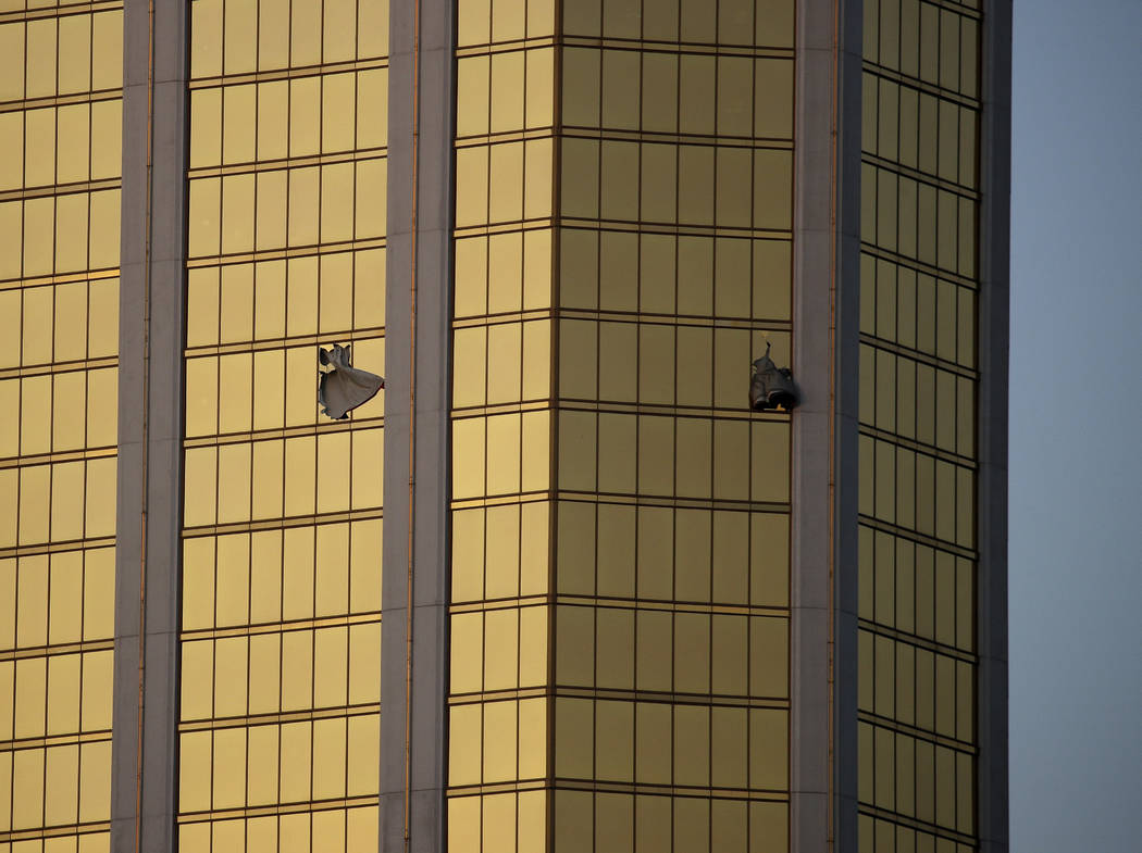 In this Oct. 2, 2017 file photo, drapes billow out of broken windows at the Mandalay Bay resort ...