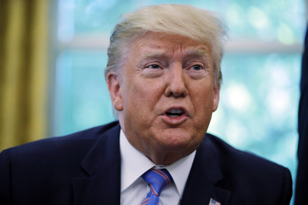 President Donald Trump talks during a signing ceremony in the Oval Office of the White House in ...