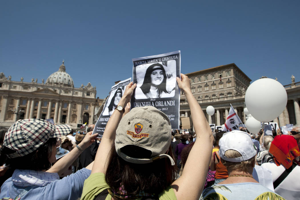 Demonstrators hold pictures of Emanuela Orlandi reading, "march for truth and justice for Emanu ...