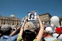 Demonstrators hold pictures of Emanuela Orlandi reading, "march for truth and justice for Emanu ...