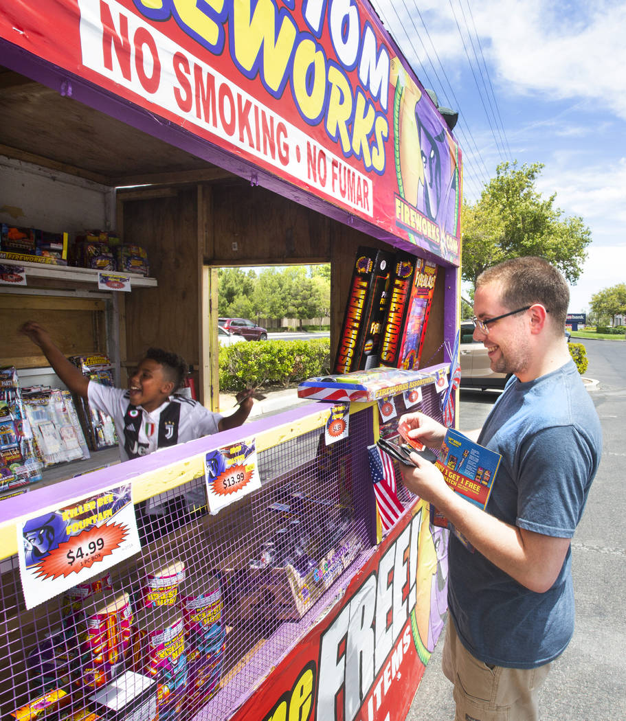 Bryce Jordan, 7, left, celebrates after Tim Meador, right, purchases fireworks on July 3, 2019 ...