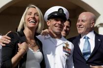 Navy Special Operations Chief Edward Gallagher, center, walks with his wife, Andrea Gallagher, ...