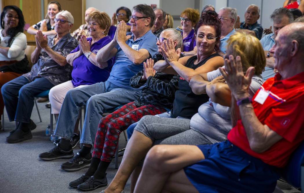 Participants do some group exercises amongst songs, stories and more during a Memory Cafe - Res ...