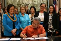 Hawaii Gov. David Ige, surrounded by members of the bipartisan Hawaii Women's Legislative Caucu ...