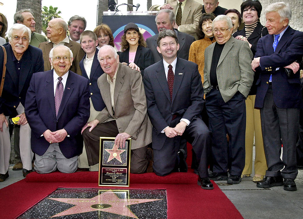 Comedian Dick Martin, center holding star, is joined by friends, family and former cast members ...