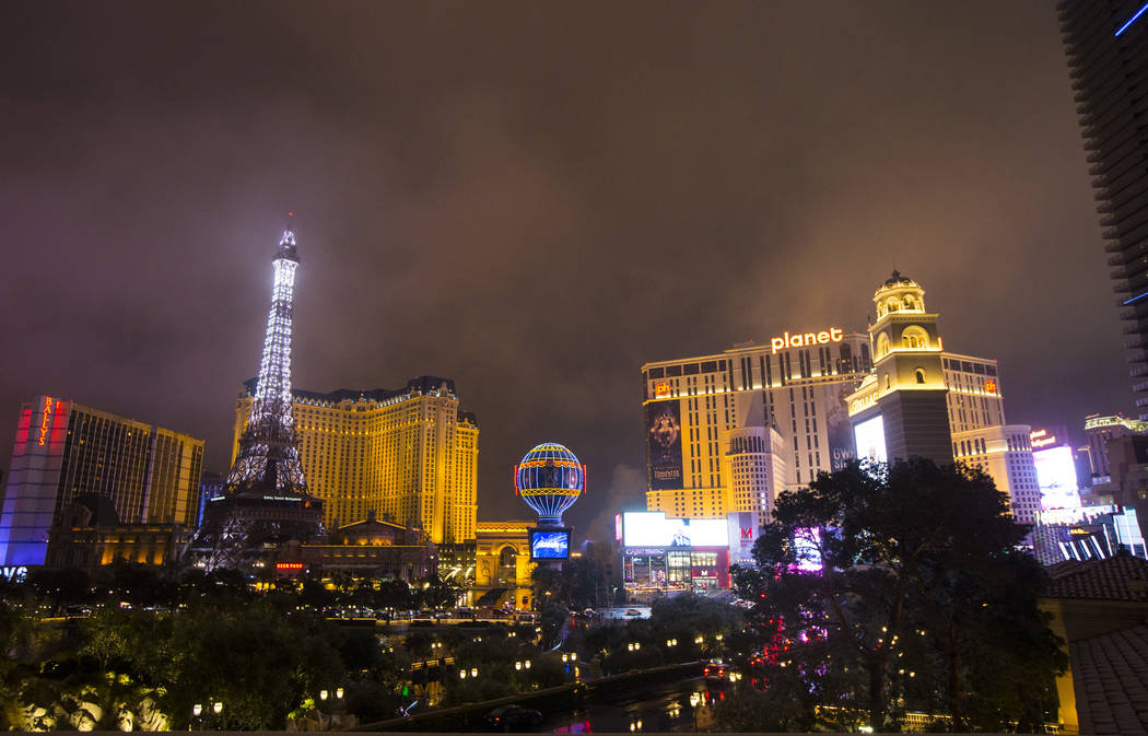 A view of the Paris Las Vegas and Planet Hollywood as snow falls in Las Vegas on Wednesday, Feb ...