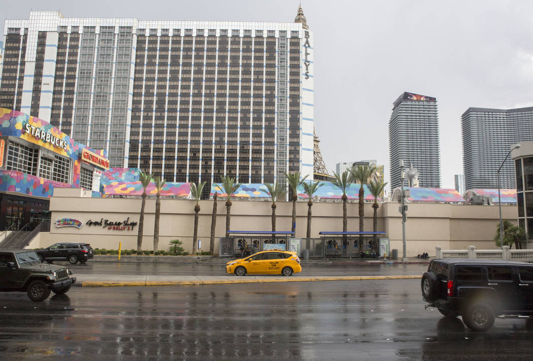 Cars drive on a wet Flamingo Road near Bally's during a rainstorm in Las Vegas on Monday, July ...