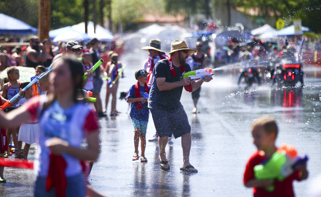 Spectators partake in water fights during the parade at the annual Damboree Celebration in Boul ...