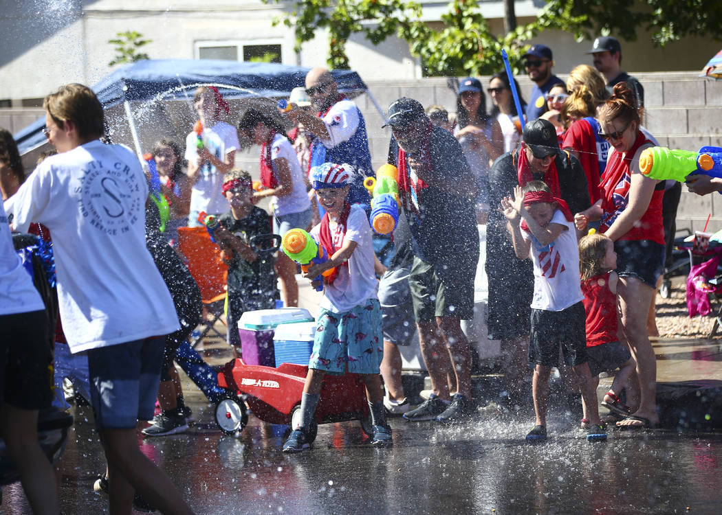 Parade spectators partake in water fights during the parade at the annual Damboree Celebration ...
