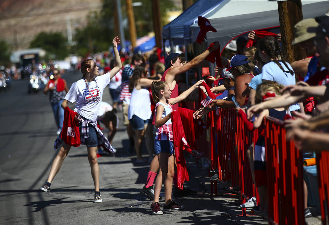Wet towels are passed out by supports of Boulder Dam Credit Union during the parade at the annu ...