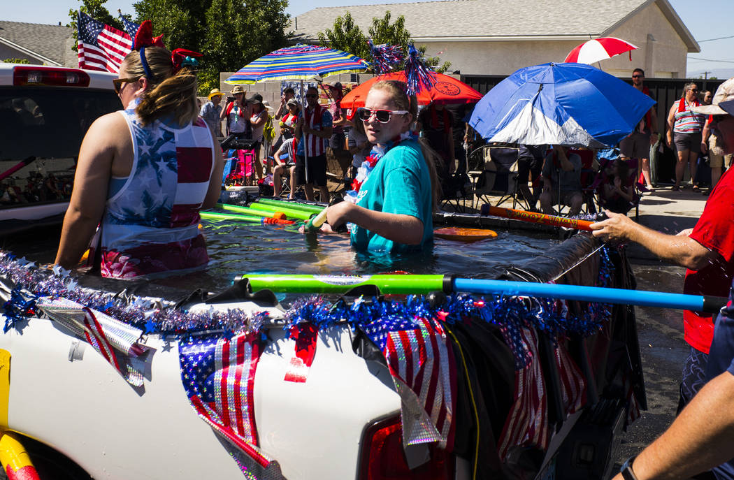 Parade participants prepare to partake in water fights during the parade at the annual Damboree ...