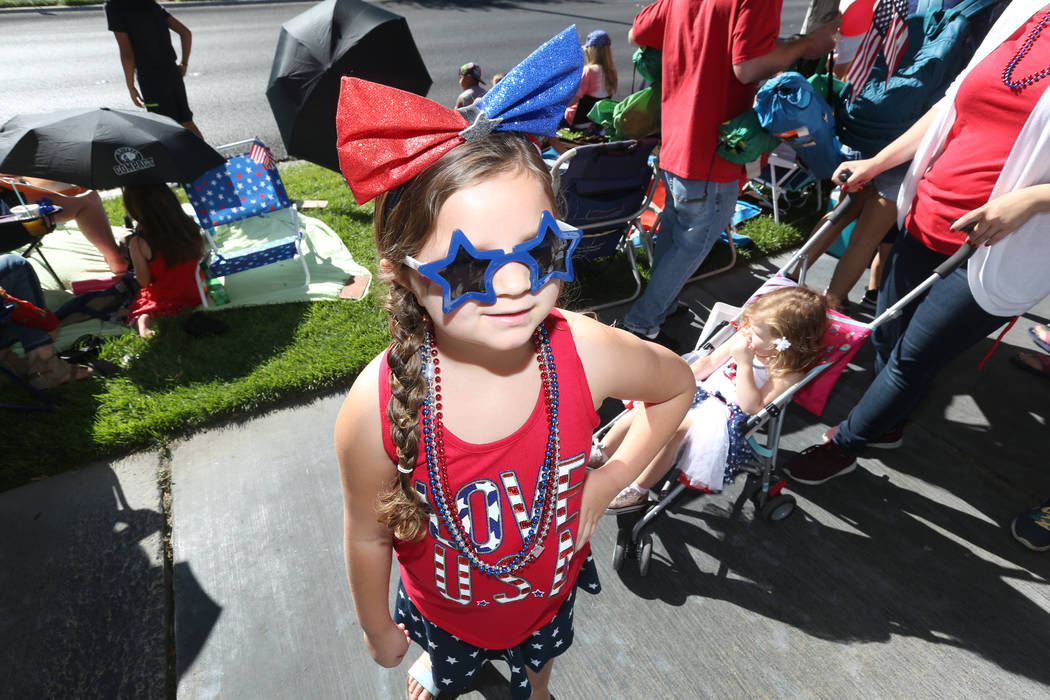 Sidonia Hambleton, 6, left, and Zella Hambleton, 2, right, wait to see floats during the 25th a ...