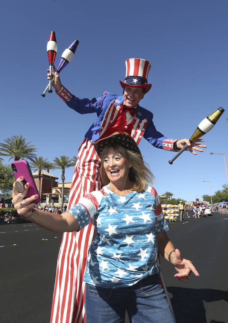 Kathy Koch takes a photo with a man dressed as Uncle Sam during the 25th annual Summerlin Counc ...