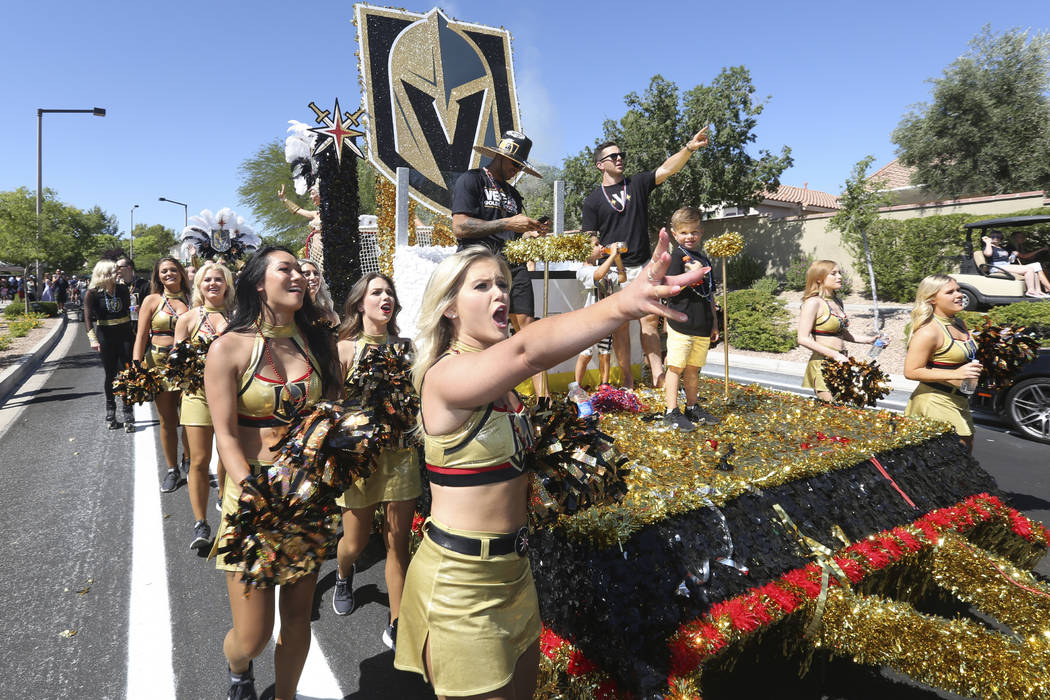 Golden Knights cheerleaders look in shock after seeing a float go up in the air during the 25th ...
