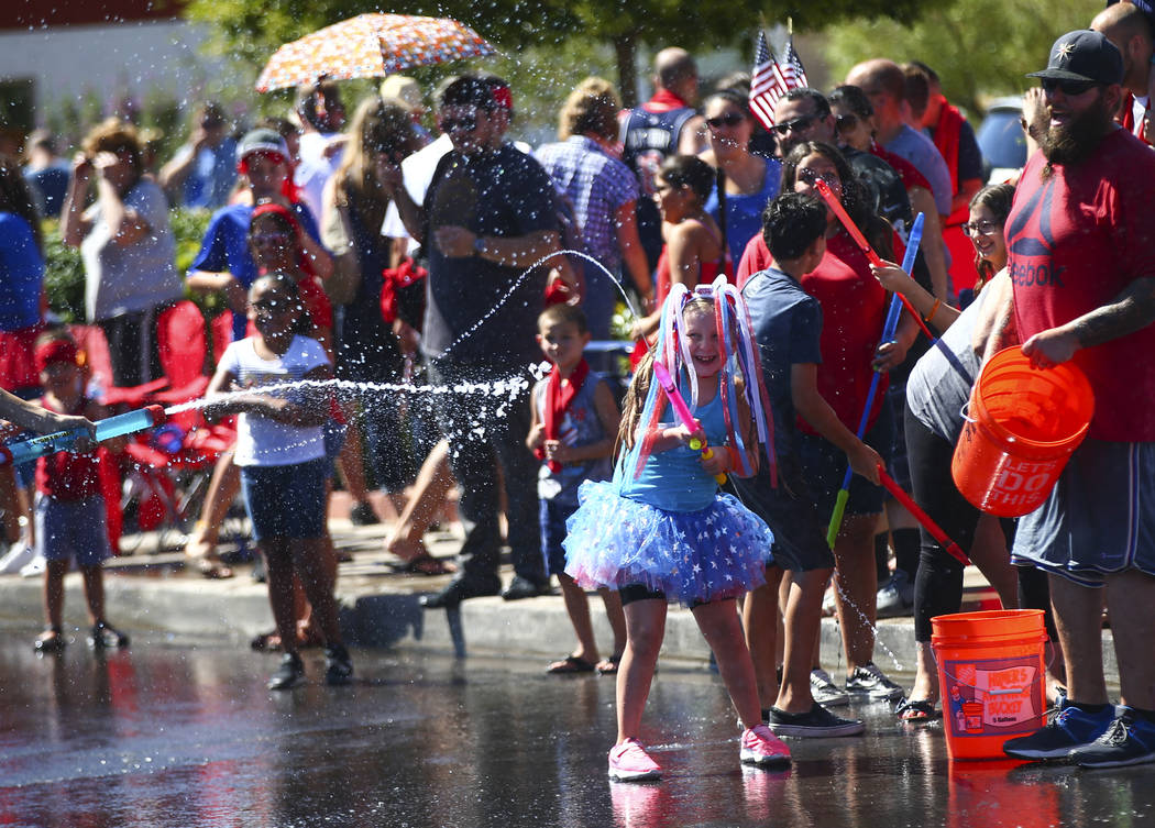 Parade spectators partake in water fights during the parade at the annual Damboree Celebration ...