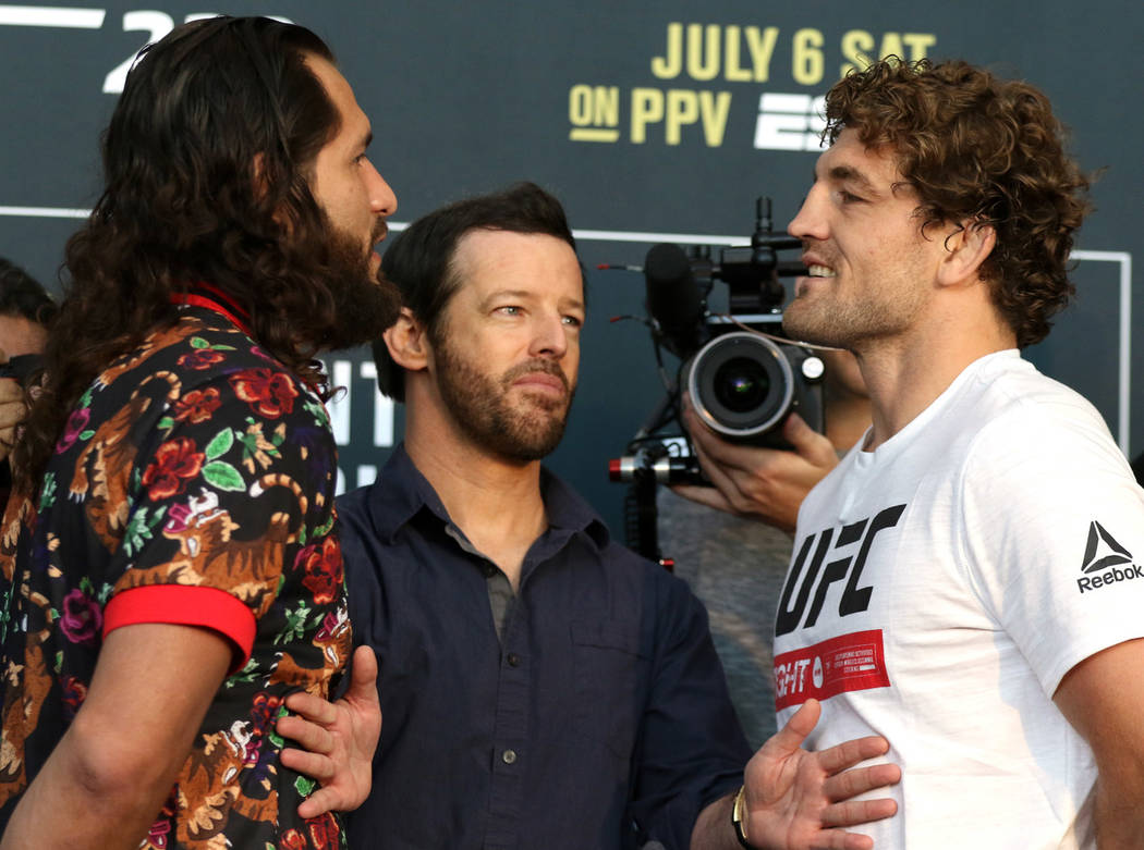 UFC welterweight Jorge Masvidal, left, and Ben Askren, right are kept apart by matchmaker Sean ...
