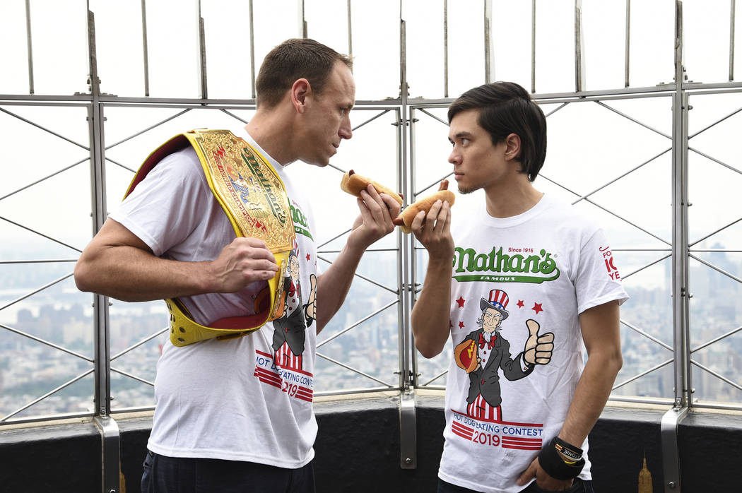 Eleven-time and defending men's champion Joey Chestnut, left, and former champion and number th ...