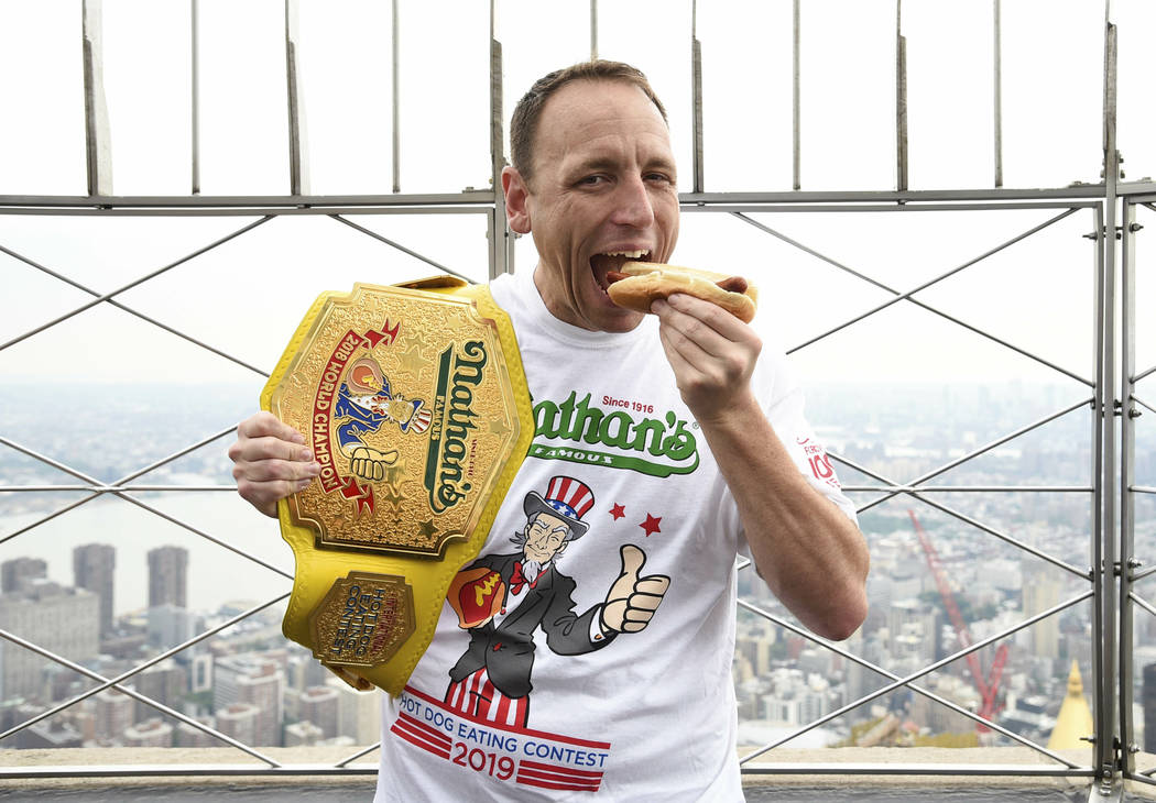 Eleven-time and defending men's champion Joey Chestnut poses on the 86th floor observation deck ...