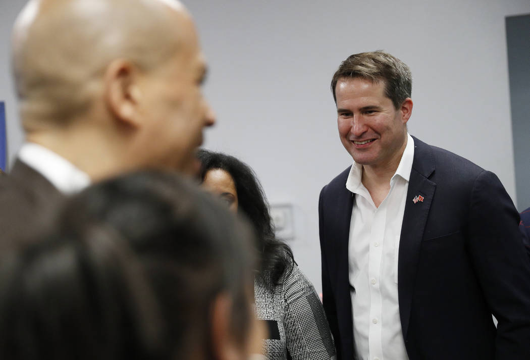 Democratic presidential candidates Rep. Seth Moulton, D-Mass., right, and Sen. Cory Booker atte ...