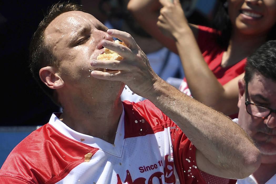 Joey Chestnut competes during the men's competition of Nathan's Famous July Fourth hot dog eati ...