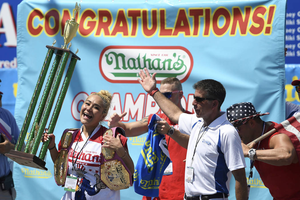 Miki Sudo reacts after receiving her trophy and belt for winning the women's competition of Nat ...