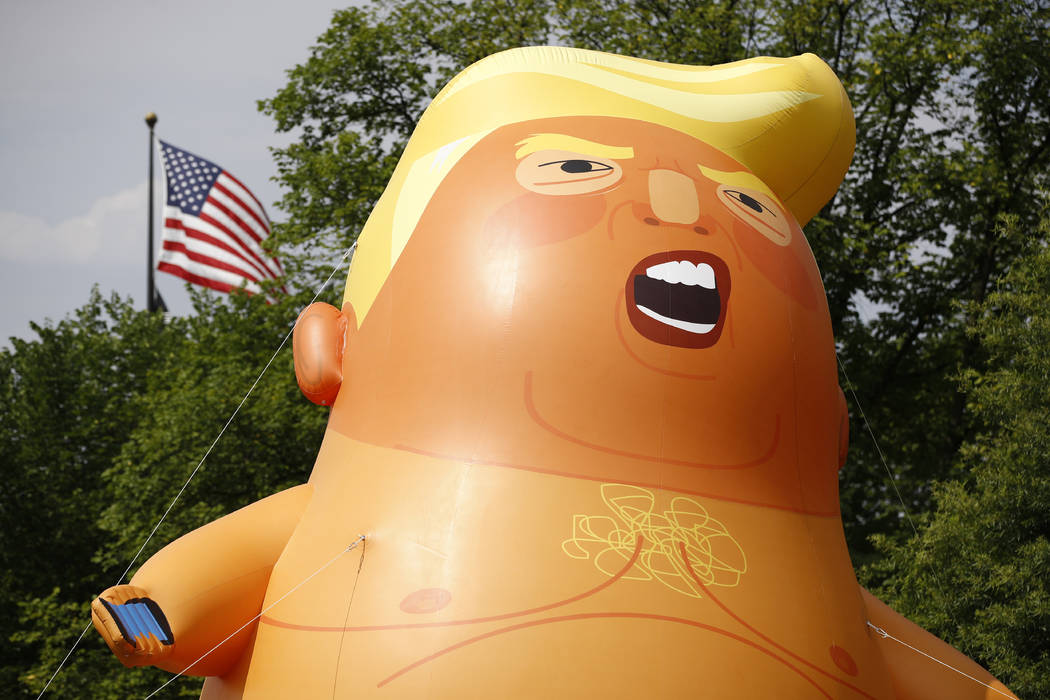 A Baby Trump balloon stands on the National Mall in Washington before Independence Day celebrat ...