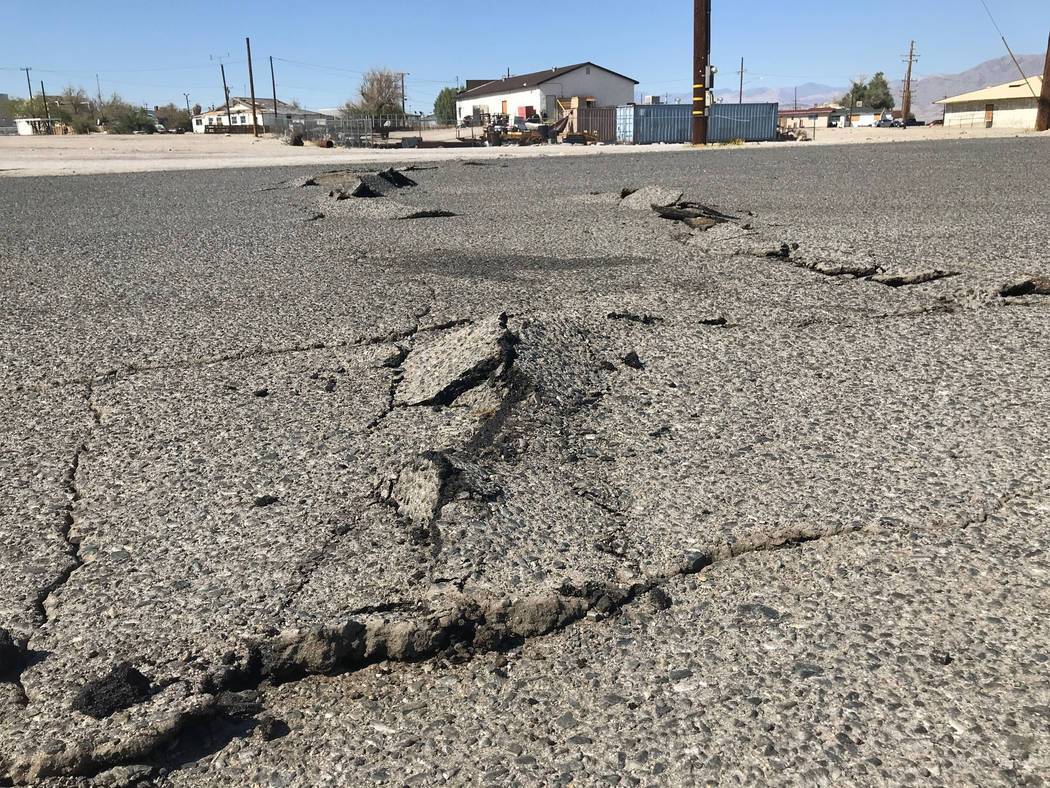 A road is damaged from an earthquake Thursday, July 4, 2019, in Trona, Calif. A strong earthqua ...