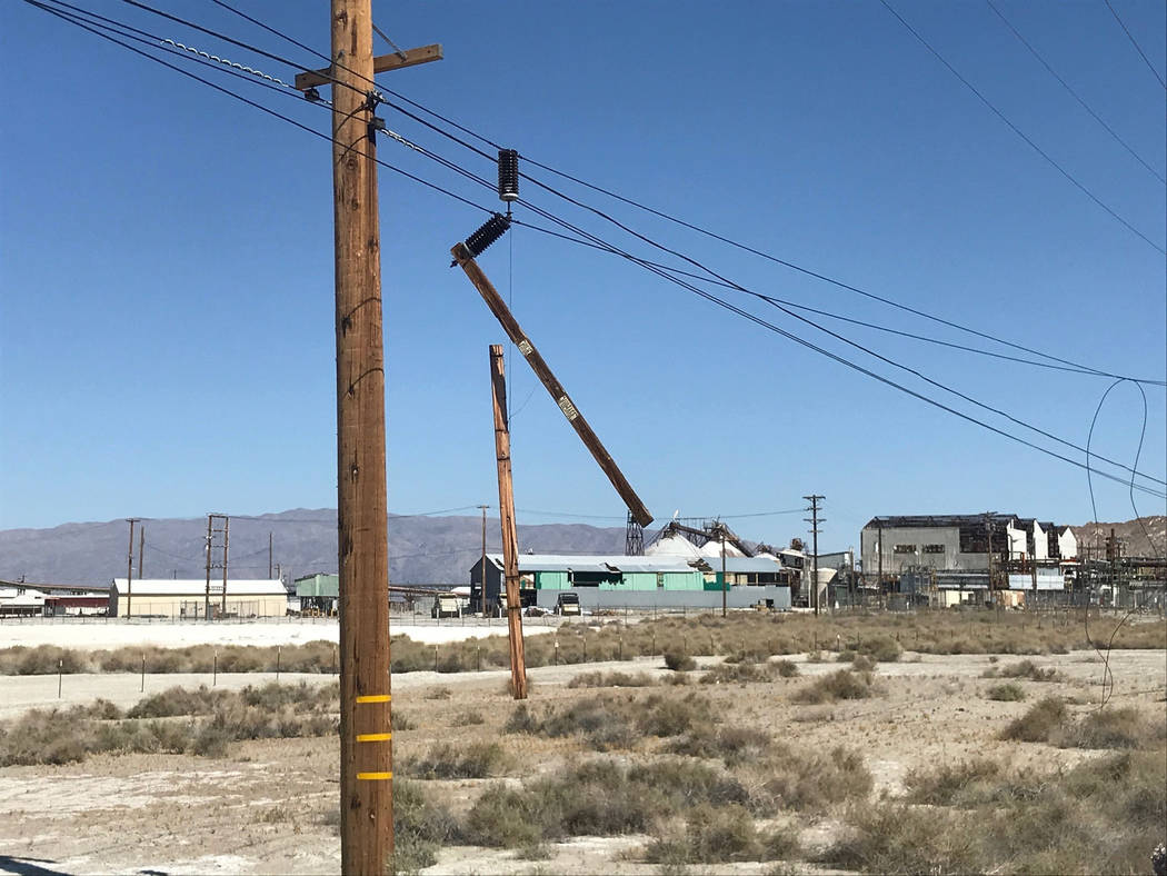 Utility poles are damaged from an earthquake, Thursday, July 4, 2019, in Trona, Calif. A strong ...