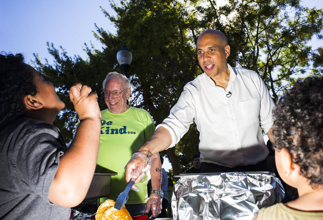 Democratic presidential candidate Sen. Cory Booker, D-N.J., serves pancakes while attending a b ...
