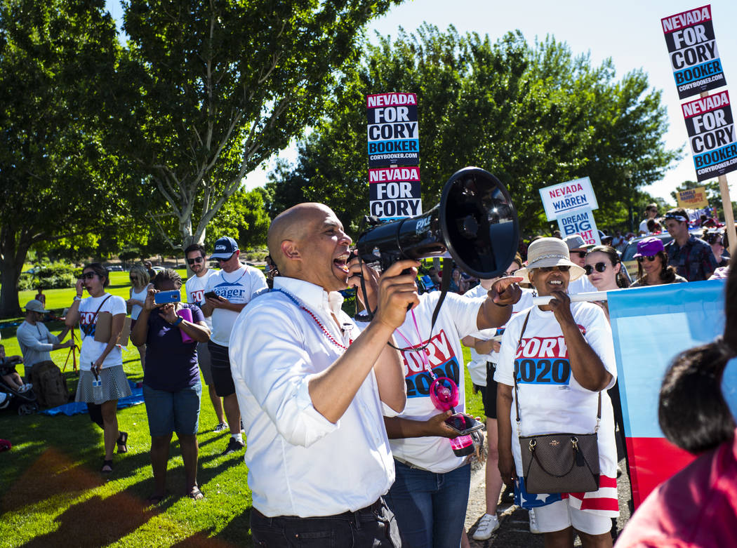 Democratic presidential candidate Sen. Cory Booker, D-N.J., uses a megaphone while talking with ...