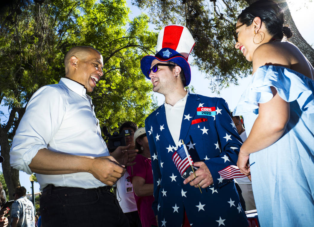 Democratic presidential candidate Sen. Cory Booker, D-N.J., left, talks with supporters Patrick ...
