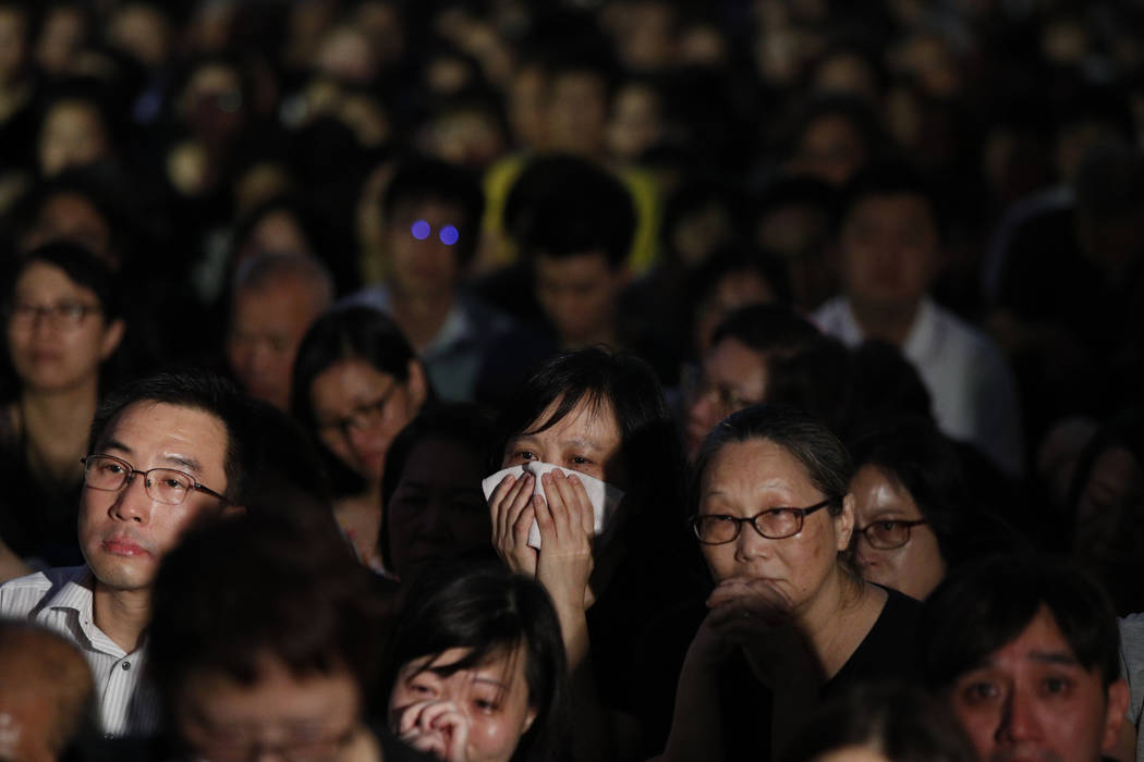 A woman cries as she joins a rally by mothers in support of student protesters in Hong Kong on ...