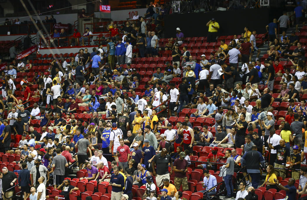 Fans leave the arena after an earthquake stopped a basketball game between the New York Knicks ...