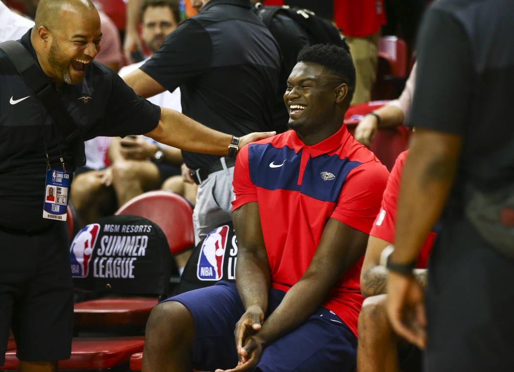 New Orleans Pelicans' Zion Williamson shares a laugh with a member of staff on his team before ...