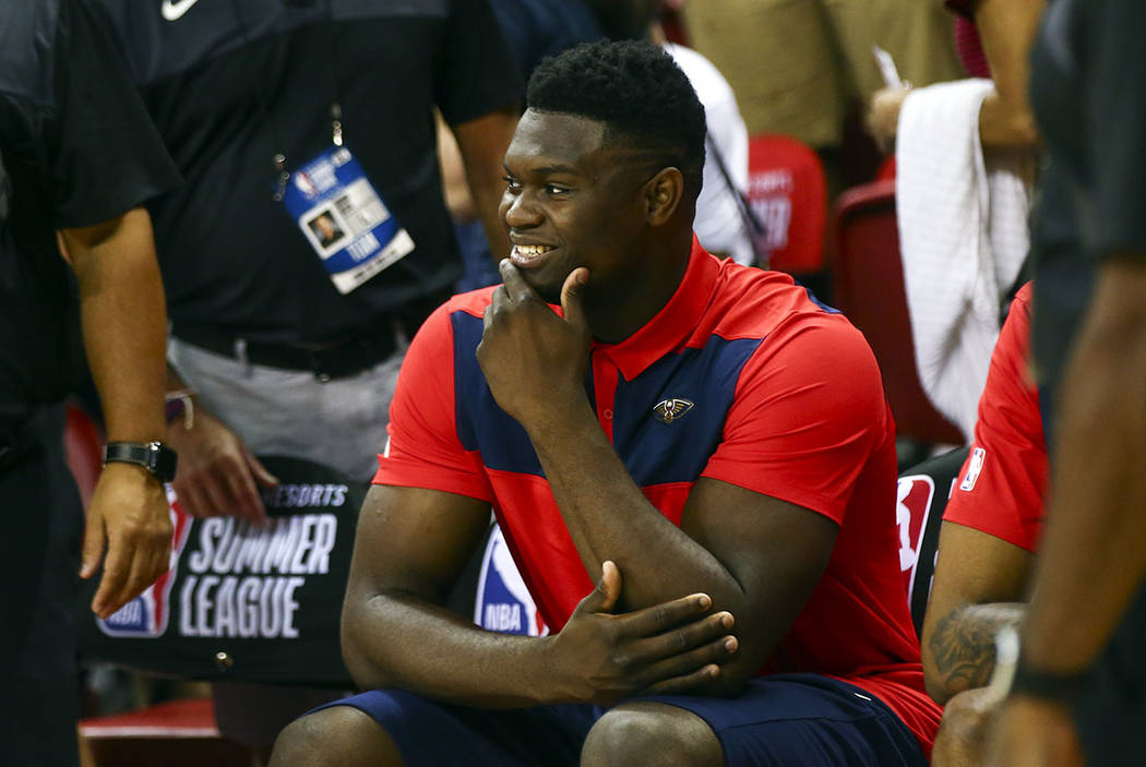 New Orleans Pelicans' Zion Williamson sits on the bench before the start of a game between the ...