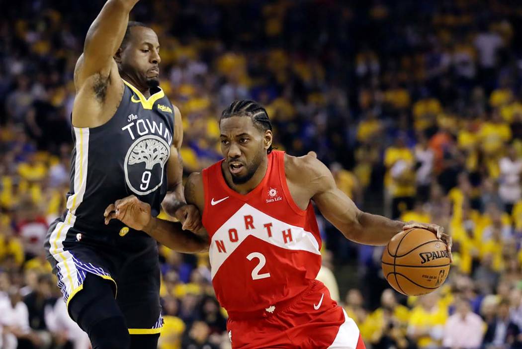 n this June 13, 2019, file photo, Toronto Raptors forward Kawhi Leonard (2) drives against Gold ...