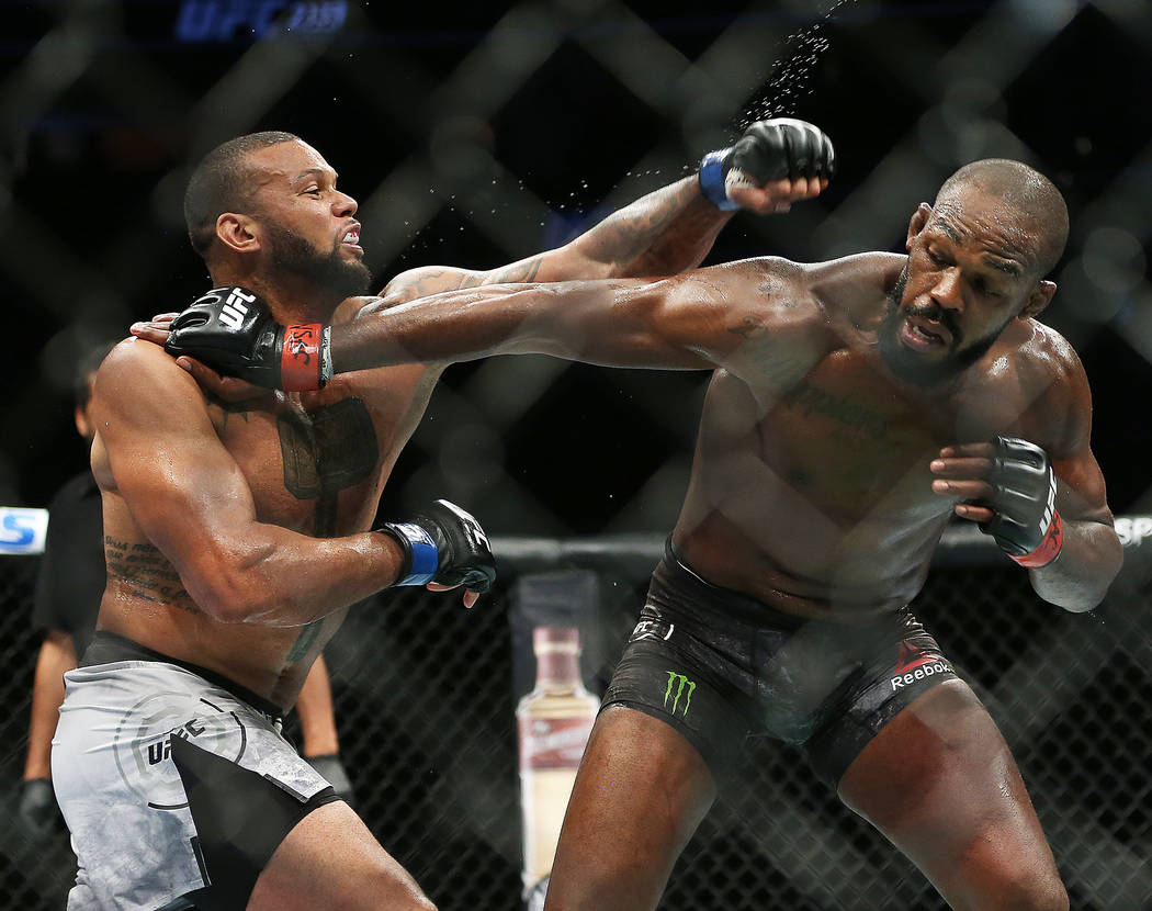 Thiago Santos, left, throws a left hook against Jon Jones in the second round during their ligh ...