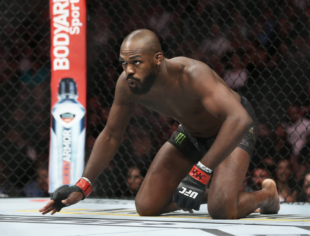 Jon Jones crawls towards the middle of the ring before the start of his light heavyweight title ...