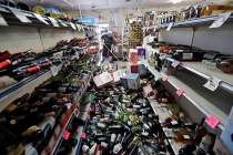 Bottles of wine are strewn in the middle of an aisle as Victor Abdullatif, background center, m ...