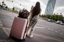 A woman stands with her suitcase near the European Central Bank as 16 000 people are evacuated ...