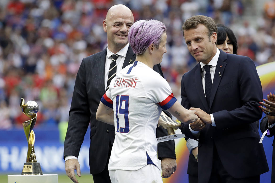 French President Emmanuel Macron, right, and FIFA President Gianni Infantino , left, congratula ...