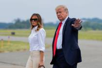 President Donald Trump and first lady Melania Trump, walk on the tarmac upon arrival at Morrist ...