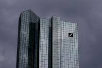 Dark clouds cover the sky over the headquarter of Deutsche Bank in Frankfurt, Germany, Sunday, ...